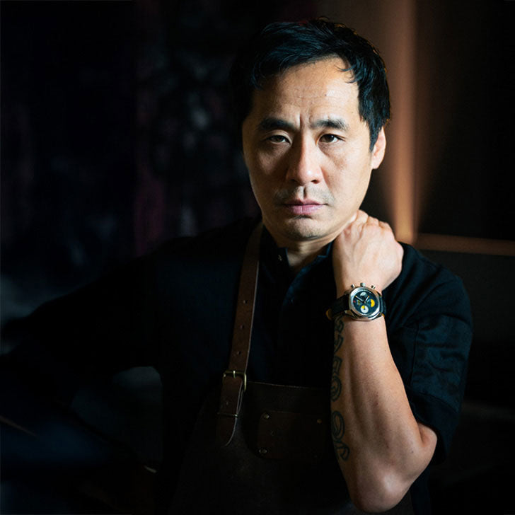 Chef wearing a Von Doren watch, posing with a serious expression.