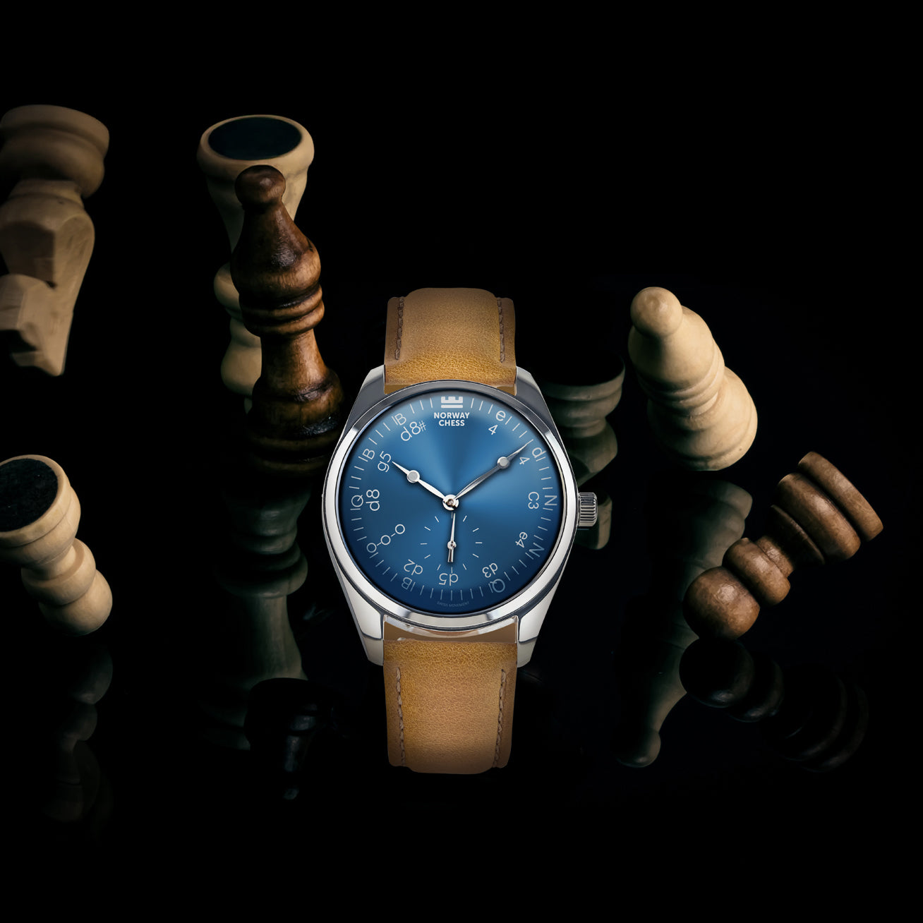 Norway Chess watch with blue dial and tan strap displayed among chess pieces on a dark background.