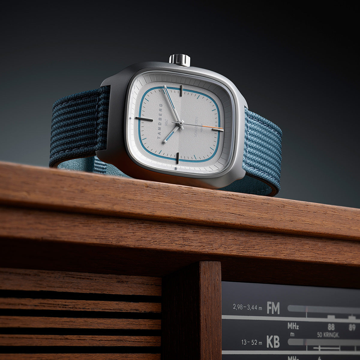 Von Doren Tandberg MKI with a light blue fabric strap placed on top of a classic wooden Tandberg radio.