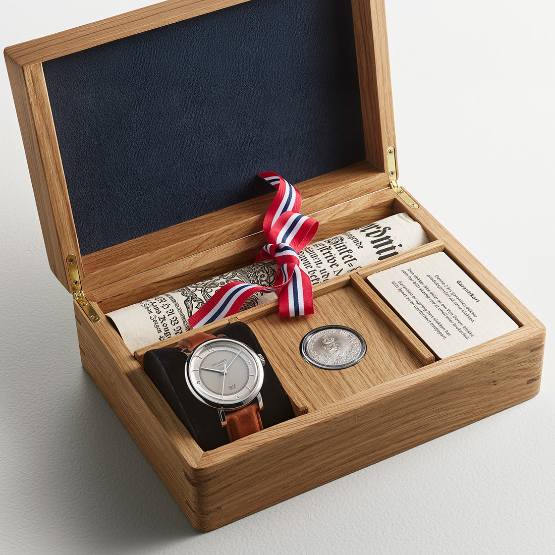 Von Doren 1814 presented in a handmade oak box with silver coin, historic document and Norwegian ribbon.