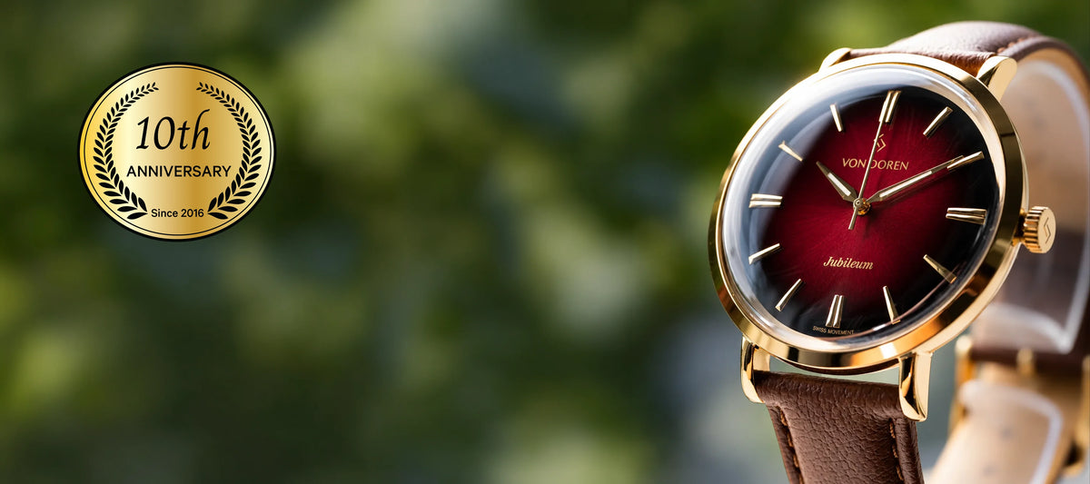 Von Doren Aksla Jubileum with a ruby red dial, gold-tone case and brown leather strap. An elegant anniversary watch inspired by Ålesund.
