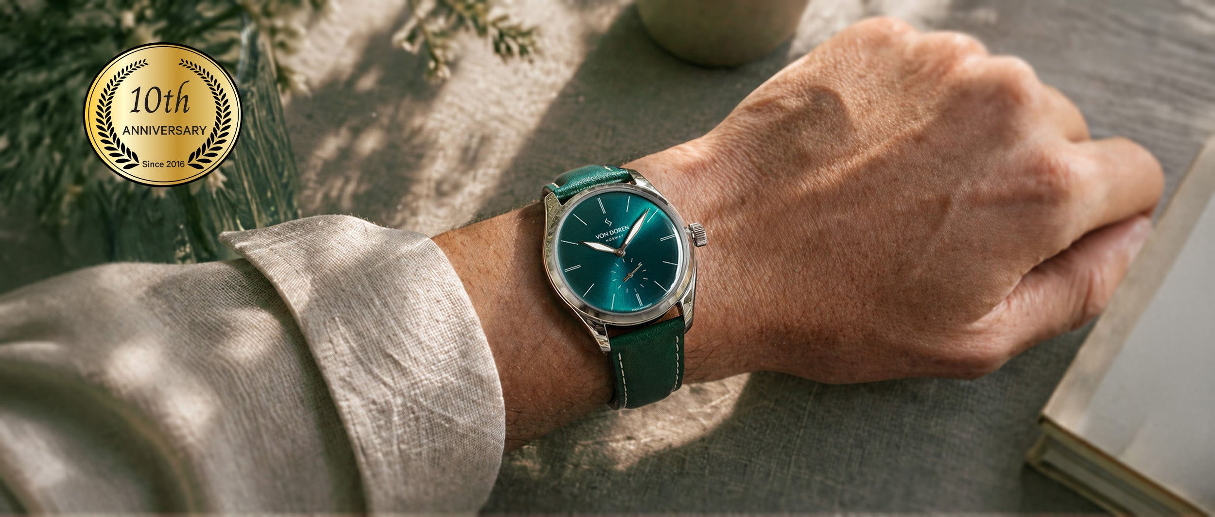 Von Doren watch with Opal sunburst dial, in warm natural light with a beige linen shirt.
